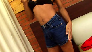 Tanned ladyboy in jean shorts teases with her small tits