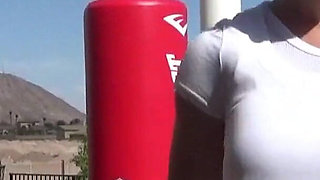 Smoking outdoor with the boxing muscled lady