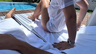 Busty chick in wet t-shirt looks for some action by a public pool