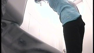 Innocent slender cutie is pissing in the toilet