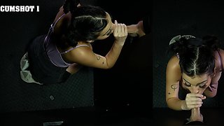 Petite brunette Lilith Grace gives a blowjob through the gloryhole.