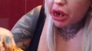 Blonde tattooed milf eats spaghetti on the toilet