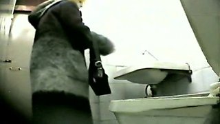 Beautiful temptress demonstrates her butt in the toilet