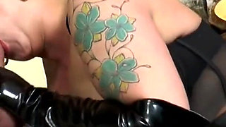 Latex chick with tattoos fucks hard with her fucker