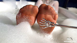 Goddess takes a foam bath in tan pantyhose and shows her wet nylon soles