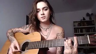 Busty emo girl plays guitar and fingers her ass