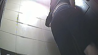 Slender white blondie in the toilet room bends over and pisses