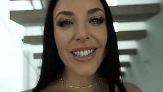 In a kitchen a sexy brunette playing with her big boobs