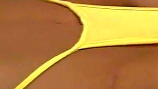 Horny wife indianna jaymes exposes her huge boobs in yellow sling thong bikini