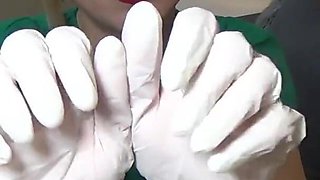 Nurse tries on exam gloves