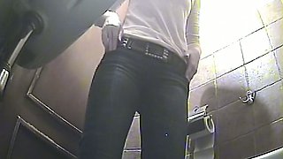 White milf in black pants pisses in the public toilet room