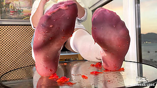My Nylon Feet Squeezing Strawberry Juice on a Glass Table