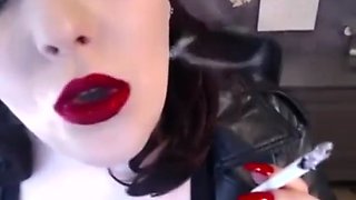 Beautiful red lipstick and nails smoking close-up
