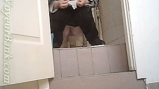 White chick in ugly baggy black pants pissing in the toilet