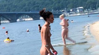 Bombastic young nudist babes sunbathe nude at the beach