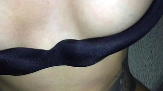 In a kitchen a sexy brunette playing with her big boobs