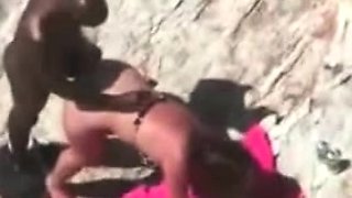 Big black dude fucking his white girlfriend at the beach