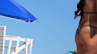 Topless beach girl in blue thong