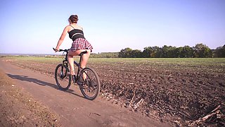 Girl Rides a Bike Under Skirt White Panties