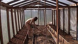 Nude house wife working in the greenhouse