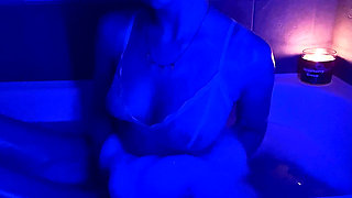 A naughty girl with juicy ass in lace gets wet from hot bubble bath while listening to emo tracks
