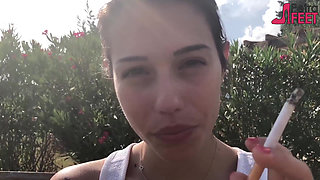 Smoking on bench with hot teen
