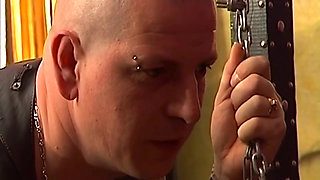 Tattooed Dom Fists Mature Blonde in Chains