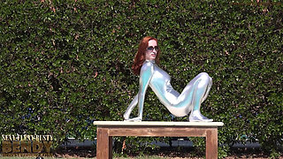 Bending in a Silver Spandex Suit