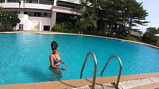 Thick Thai bombshell flaunts her phony funbags in a skimpy swimsuit