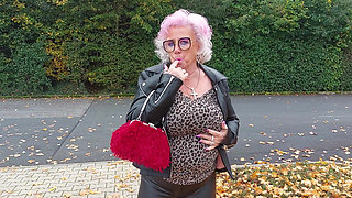 Naughty Granny Tongue Out Flashing Big Tits in Public