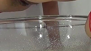 A MILF in Red Is Peeing Into a Basin.