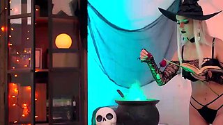A blond doll in a witch hat and black with cum