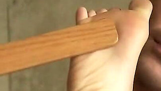 Chained teen enjoys hot wax punishment and dildo penetration