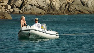 A girl with big boobs is having fun on the beach with her boyfriend.