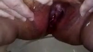 Closeup of Jen pissing in the porta potti