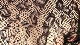 I'm Posing in a Black Fishnet Bodysuit and Heels, Pleasuring Myself with My Fingers.