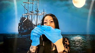 Dominatrix Nika with a glove fetish puts on medical gloves and destroys them with her long tools