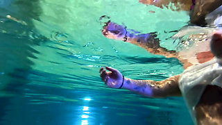 Amazon Kandy Flexes Her Massive Biceps in Her Hotel Pool