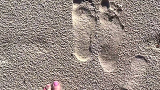 Comparing Size 16 Feet to Sand Prints at the Beach