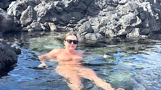 Nudist Girl Swimming Naked in the Natural Pool Outdoor