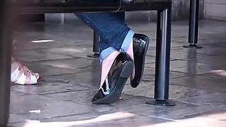 Crossed Ankle Blonde woman flats shoeplay POV