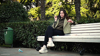 Young Brunette Is Taking an Unhurried Stroll with Allwhite 120mm Cigarette