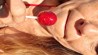 Melissa Johnson Sucks and Licks a Cherry Lollipop on the.beach