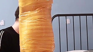 A Cute Barefoot Girlfriend Uses Tape to Bind Her Whole Body, Playing with Her Cute Bare Feet