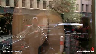 Slave posing naked in public window