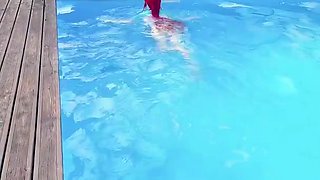 Cosplay redhead teen seductress posing in bikini in the pool